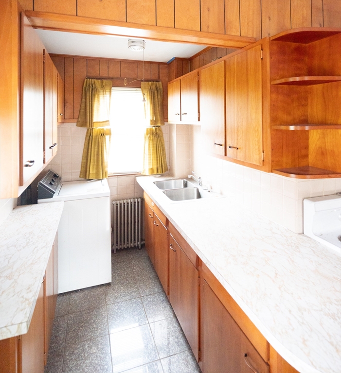 4 Winter Street Clinton, MA 01510 - Photo 24 of 33 a kitchen with a sink a stove and a refrigerator