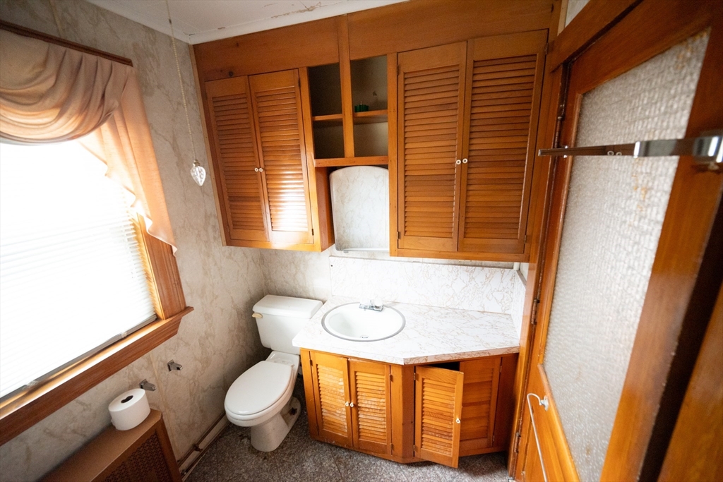 4 Winter Street Clinton, MA 01510 - Photo 25 of 33 a bathroom with a granite countertop sink and a mirror