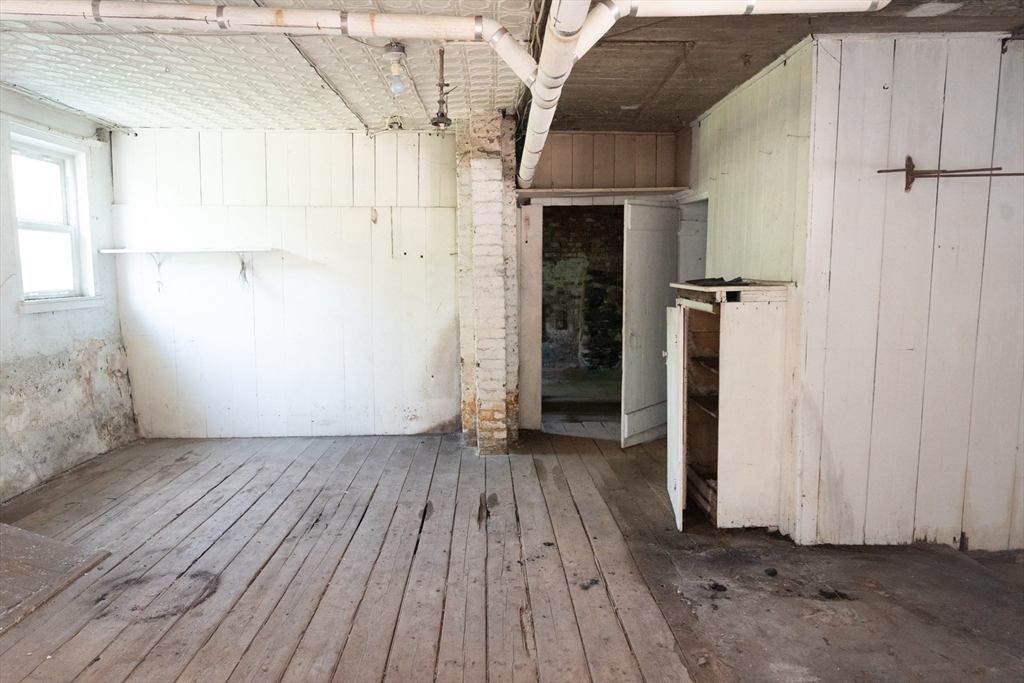 4 Winter Street Clinton, MA 01510 - Photo 30 of 33 an empty room with wooden floor and entrance