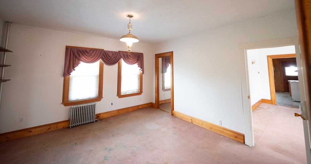 4 Winter Street Clinton, MA 01510 - Photo 7 of 33 an empty room with windows and chandelier fan