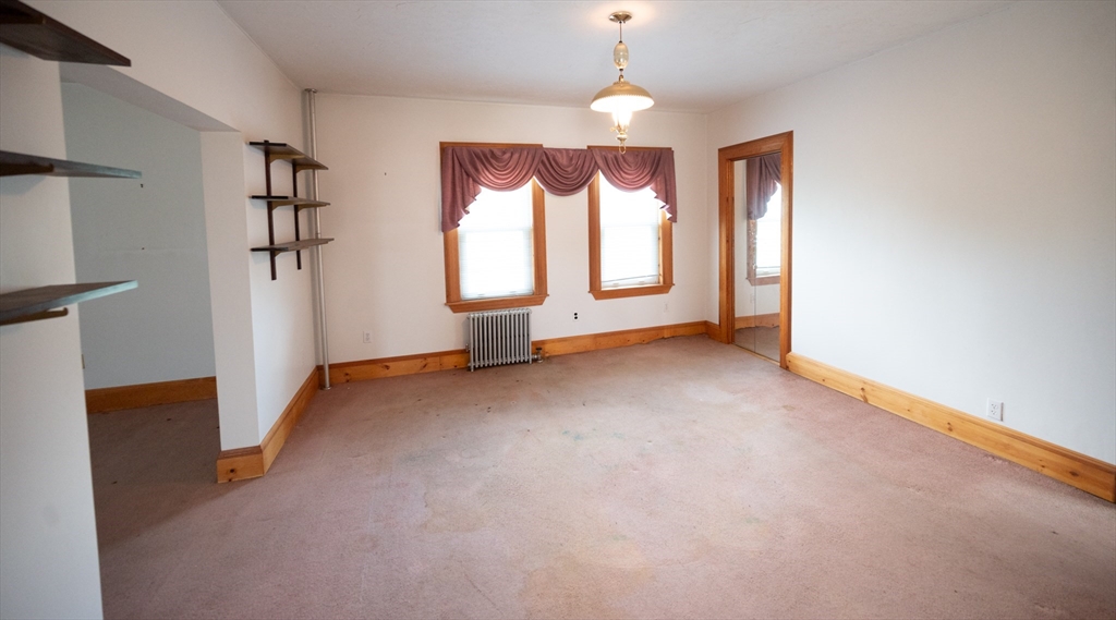4 Winter Street Clinton, MA 01510 - Photo 8 of 33 an empty room with windows and chandelier fan