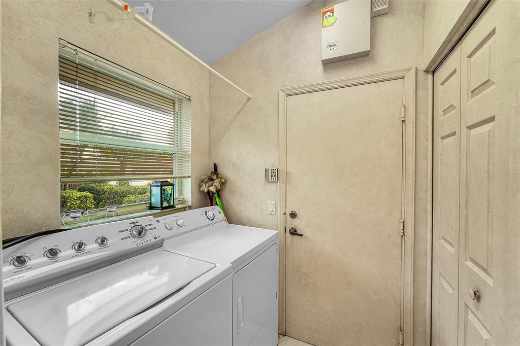 6898 Grenelefe Road Boynton Beach, FL 33437 - Photo 22 of 65 a bathroom with a granite countertop sink a large mirror and a bathtub