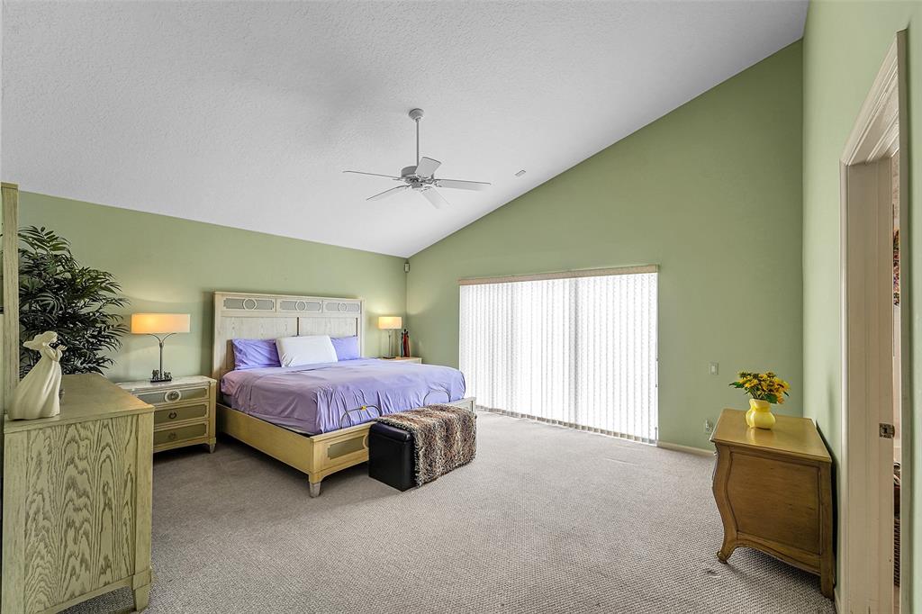 6898 Grenelefe Road Boynton Beach, FL 33437 - Photo 23 of 65 a spacious bedroom with a bed and a couch