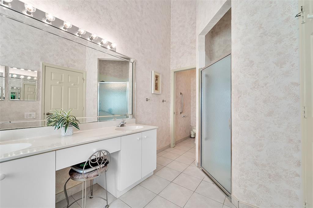 6898 Grenelefe Road Boynton Beach, FL 33437 - Photo 27 of 65 a spacious bathroom with a granite countertop sink and a mirror