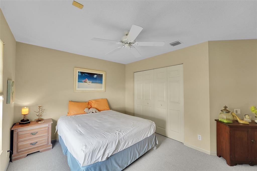 6898 Grenelefe Road Boynton Beach, FL 33437 - Photo 32 of 65 a bedroom with a bed and a chandelier