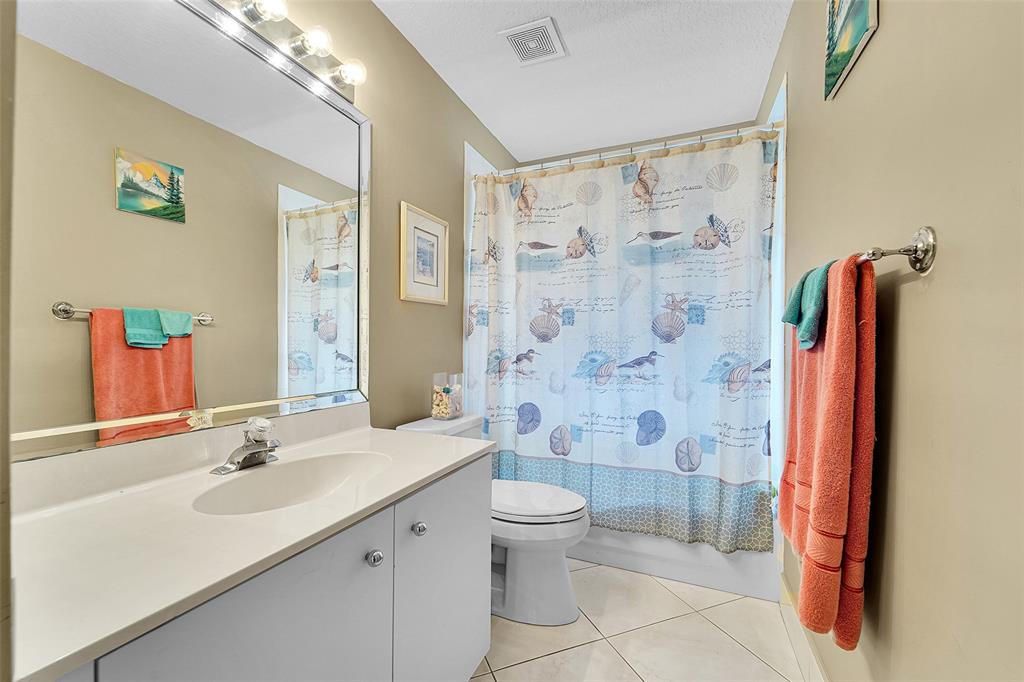 6898 Grenelefe Road Boynton Beach, FL 33437 - Photo 35 of 65 a bathroom with a sink a toilet and shower