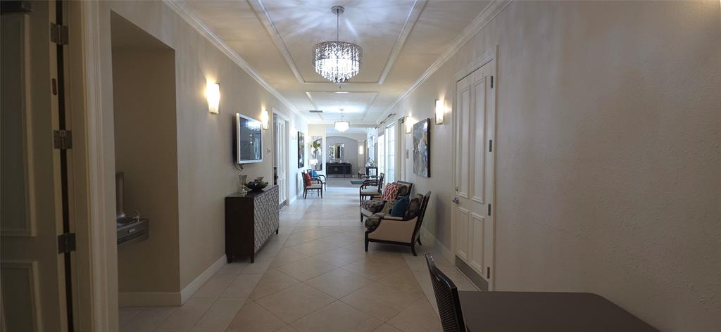 6898 Grenelefe Road Boynton Beach, FL 33437 - Photo 47 of 65 a view of a hallway with couches and chandelier