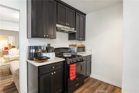 a kitchen with stainless steel appliances a stove a sink and a microwave