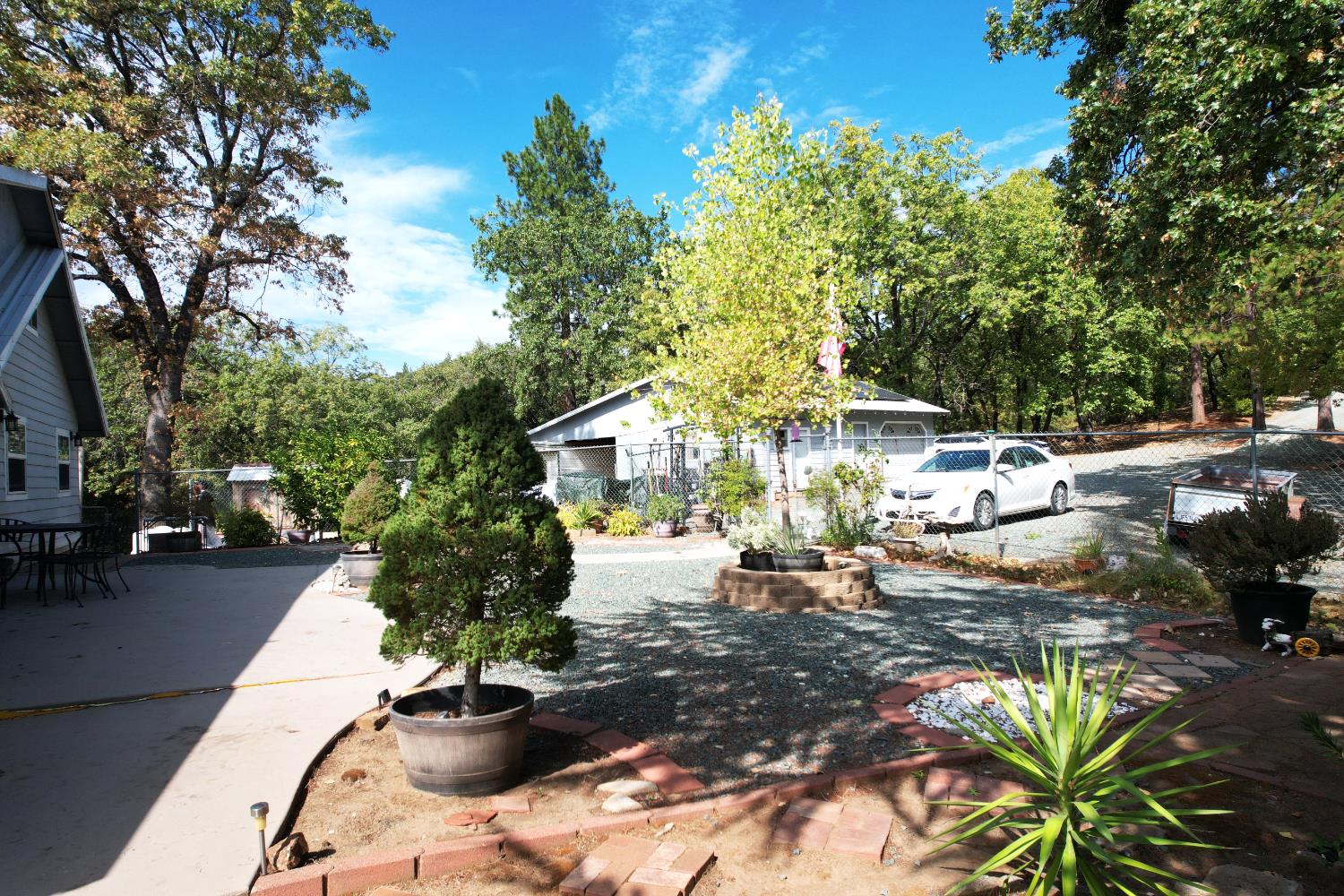 20480 Timber Ridge Road Pine Grove, CA 95665 - Photo 11 of 56 a view of a patio with table and chairs and potted plants