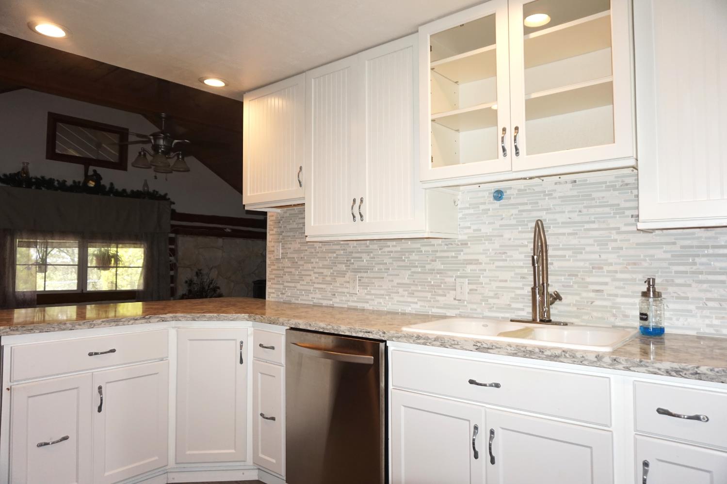 20480 Timber Ridge Road Pine Grove, CA 95665 - Photo 22 of 56 a kitchen with granite countertop white cabinets and white appliances