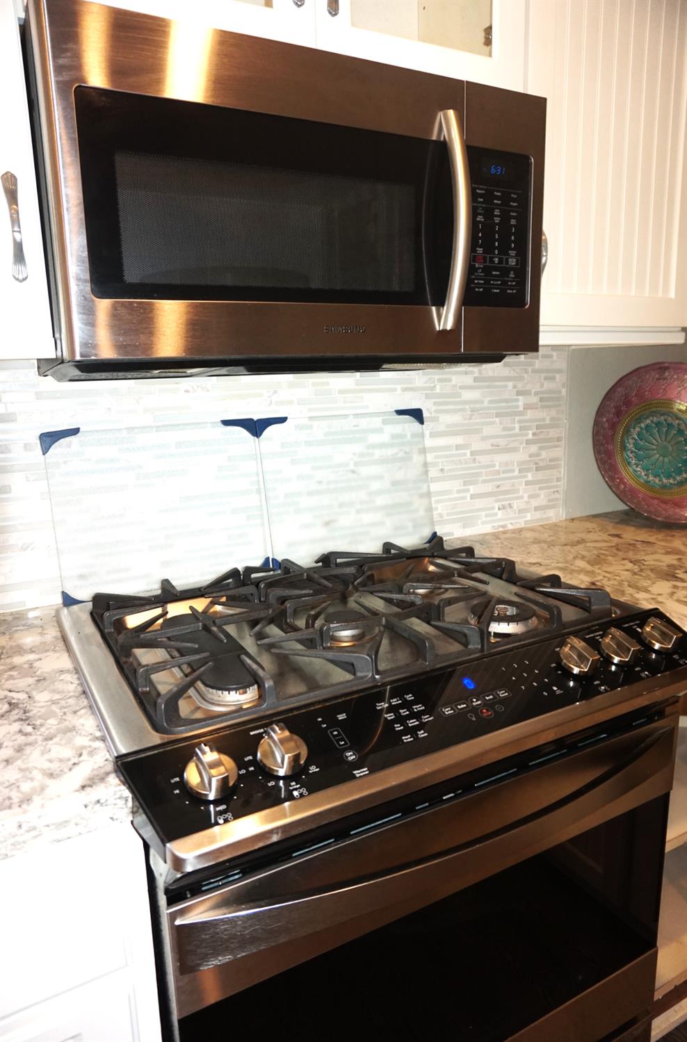 20480 Timber Ridge Road Pine Grove, CA 95665 - Photo 23 of 56 a close up of a stove a microwave and cabinets