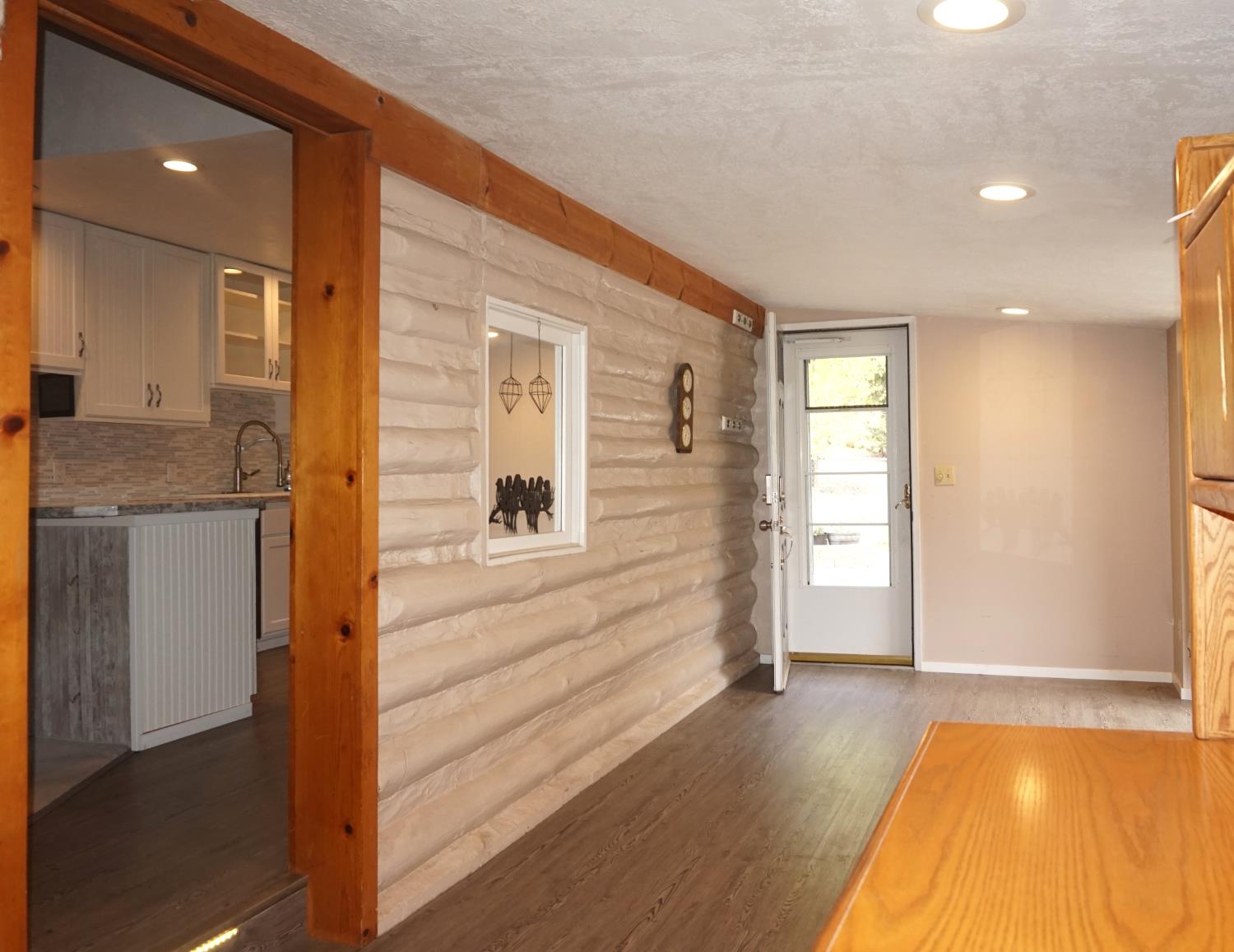 20480 Timber Ridge Road Pine Grove, CA 95665 - Photo 25 of 56 a view of a hallway with wooden floor and cabinet with a living room