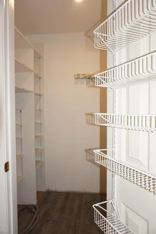 an empty room with wooden floor and a window