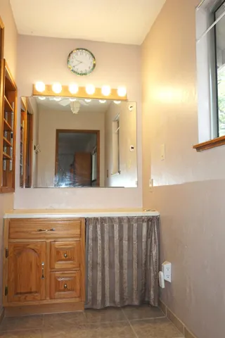 a front view of a house with cars parked