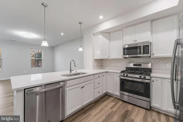 a kitchen with a sink stove and microwave