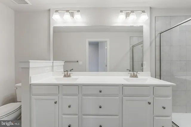 a bathroom with 2 sink and a mirror