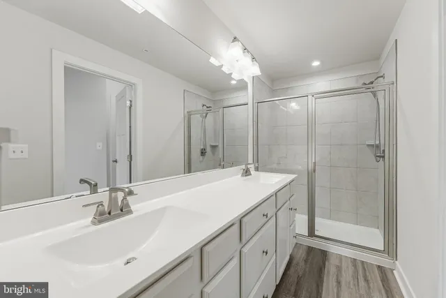 a bathroom with a sink double vanity and a mirror