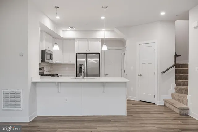 a large kitchen with cabinets and stainless steel appliances