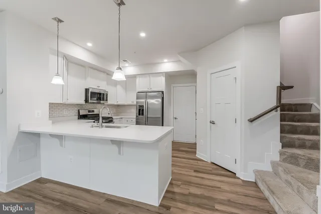 a view of kitchen with sink microwave refrigerator and outdoor view