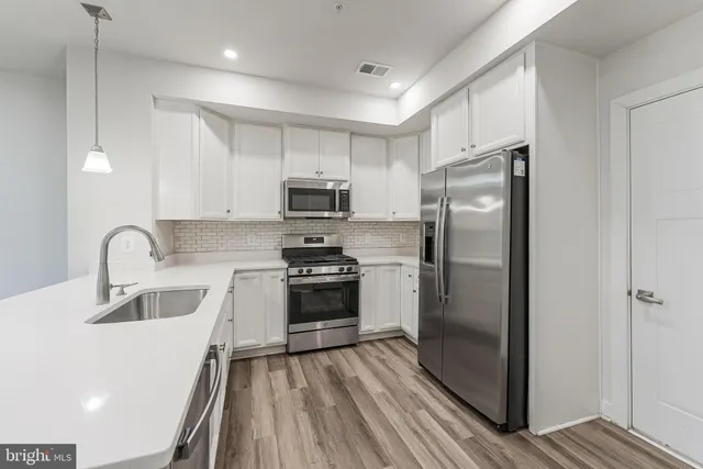a kitchen with a refrigerator a sink and a stove