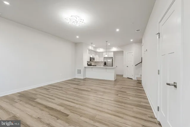 a view of a kitchen with a sink and refrigerator