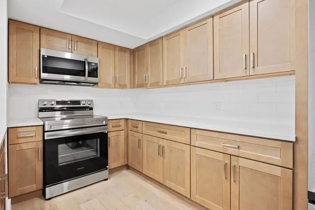 a kitchen with a sink and stainless steel appliances