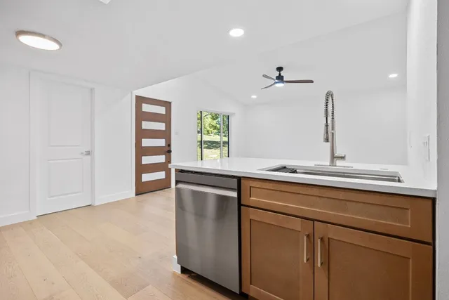 a kitchen with white cabinets stainless steel appliances and sink