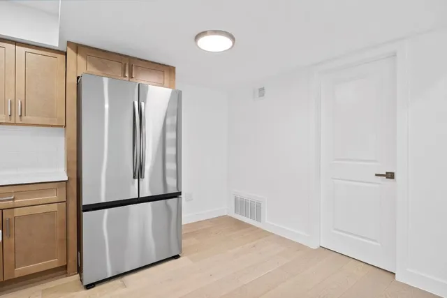 a kitchen with stainless steel appliances a refrigerator and cabinets