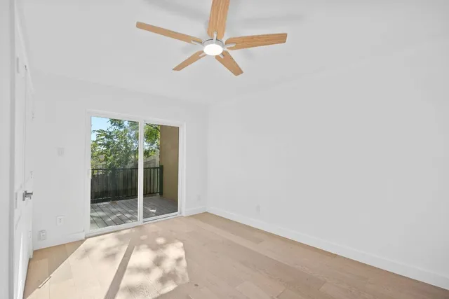 a view of kitchen with stainless steel appliances wooden floor
