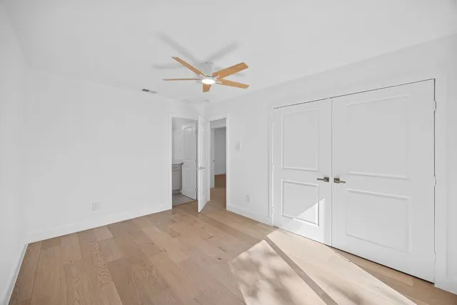 a view of a livingroom with a ceiling fan and window