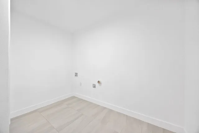 an empty room with a window and ceiling fan