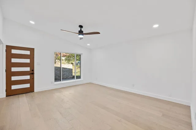 a view of an empty room with a ceiling fan