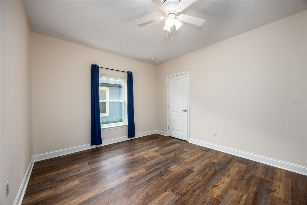 8216 Northwest 54th Street Gainesville, FL 32653 - Photo 17 of 58 a view of an empty room with wooden floor and a window
