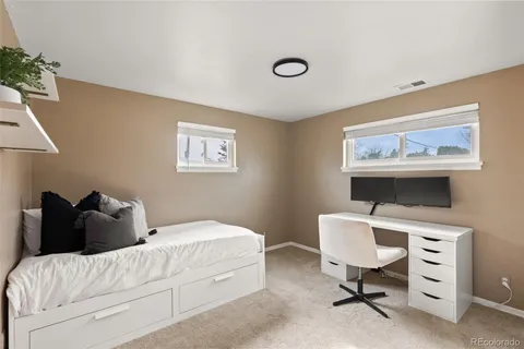 a bedroom with a bed and a desk