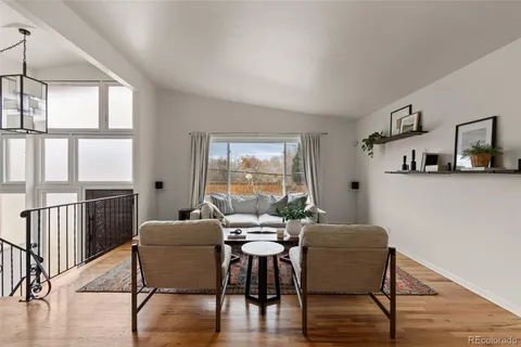 a view of a dining room with furniture window and wooden floor