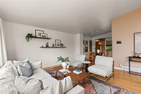 a living room with furniture and wooden floor