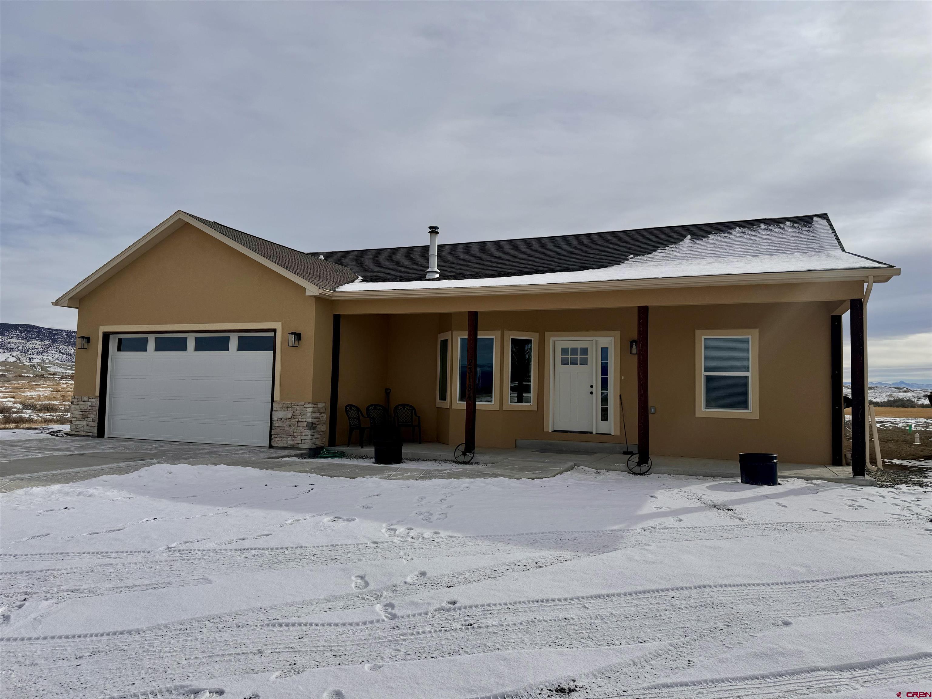 23184 D50 Road Delta, CO 81416 - Photo 1 of 23 a front view of a house with a yard and garage