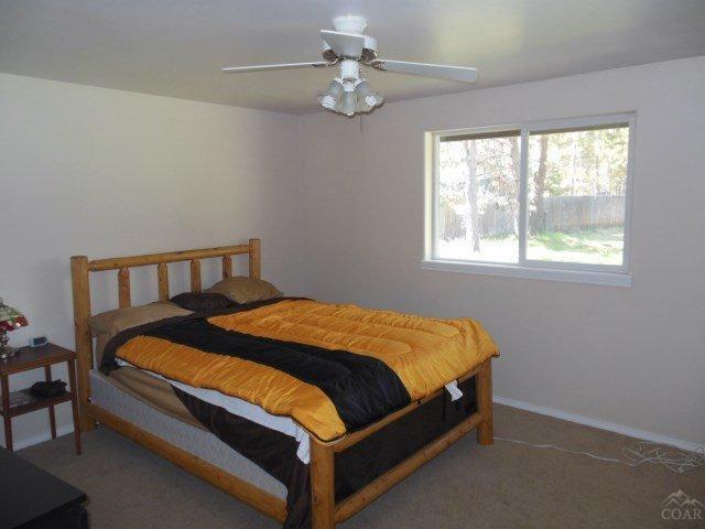 17246 Indio Road Bend, OR 97707 - Photo 10 of 21 a bed sitting in a bedroom next to a window