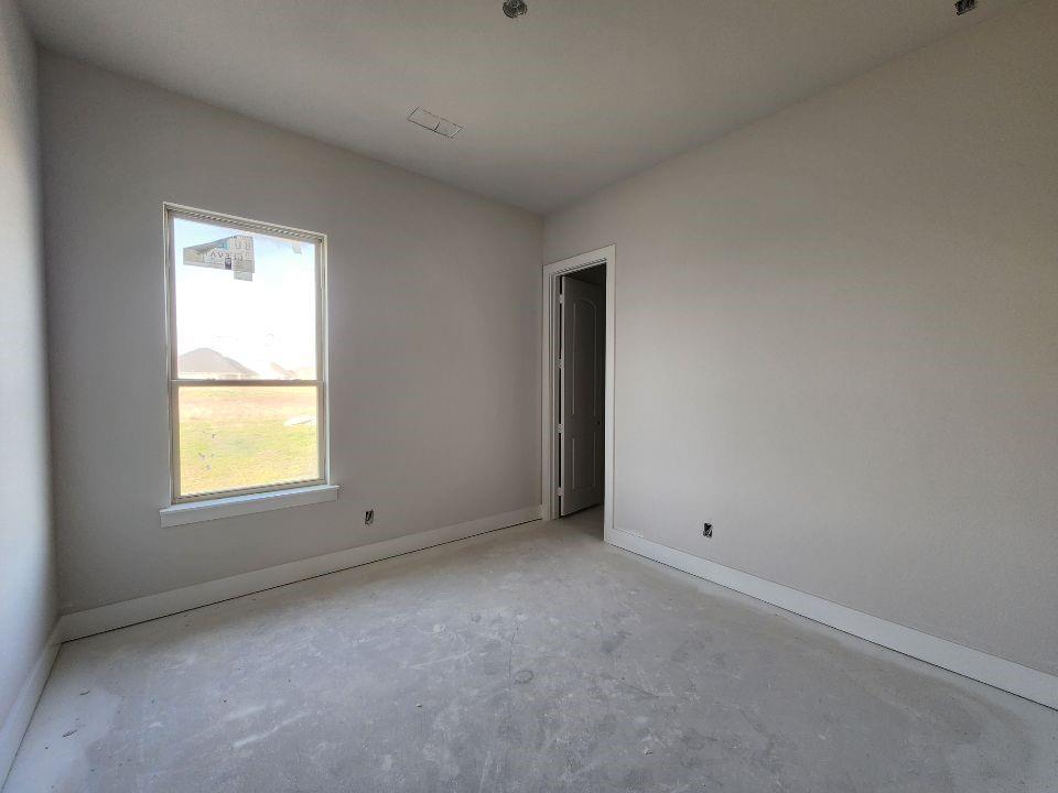 12412 Delta Court Krum, TX 76249 - Photo 12 of 18 an empty room with a window