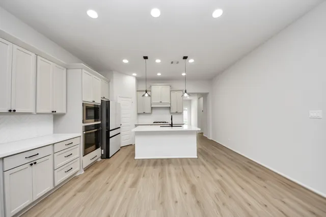 a view of an empty room with window and closet area