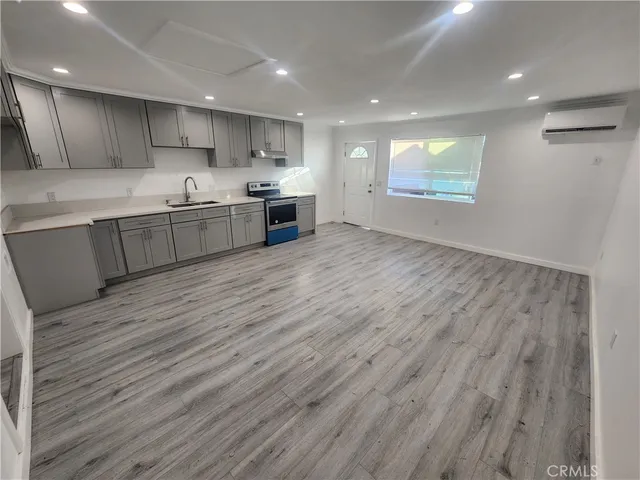 a large kitchen with stainless steel appliances granite countertop a wooden cabinets a stove a sink and a dishwasher