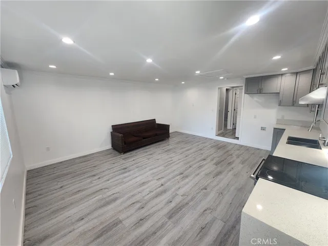 a room with wooden floor and outdoor space