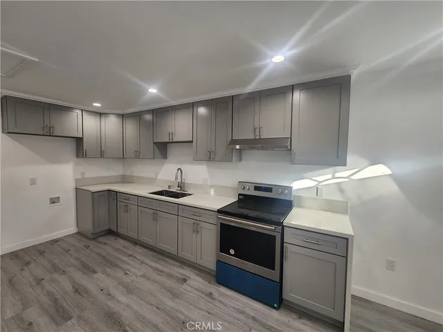 a kitchen with granite countertop a sink and cabinets