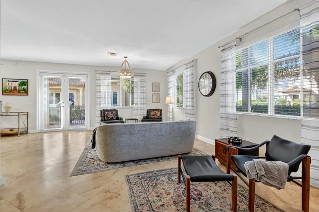 a living room with furniture and a book shelf