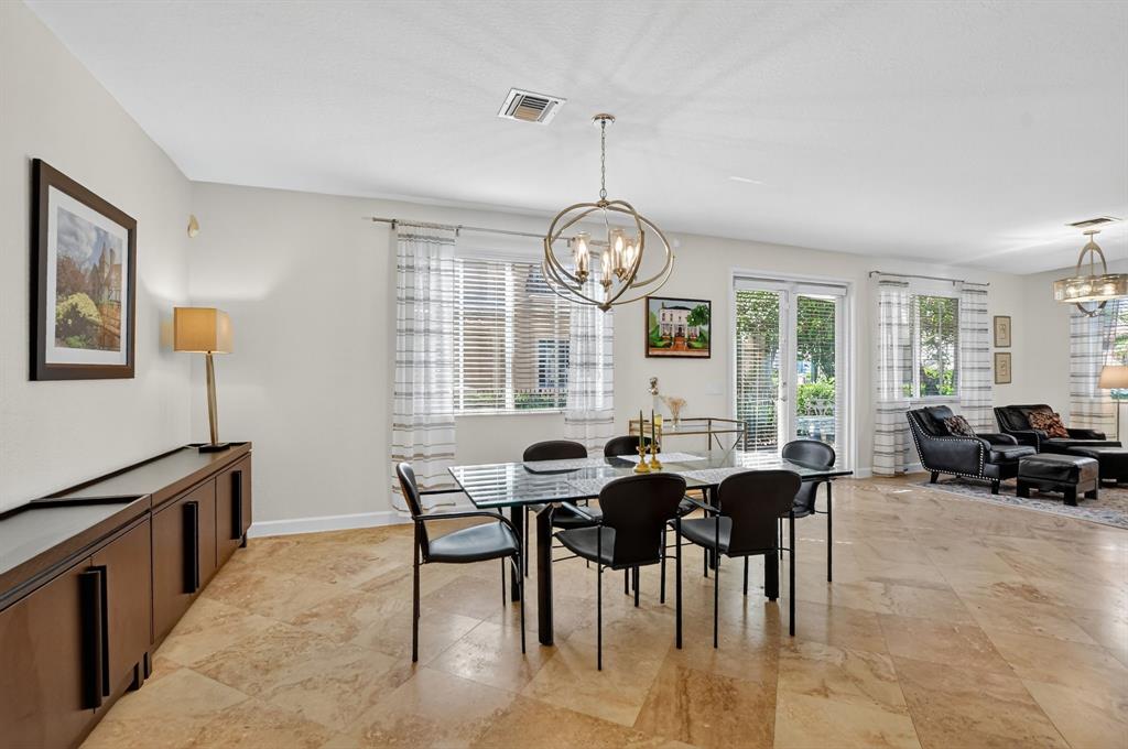591 Northwest Library Commons Way Boca Raton, FL 33432 - Photo 27 of 75 a view of a dining room with furniture window and wooden floor