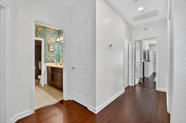 a view of a workspace with furniture and a bookshelf