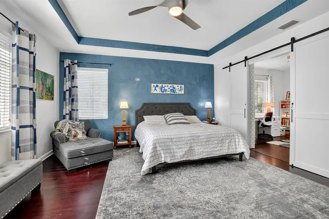 a bedroom with furniture and a wooden floor