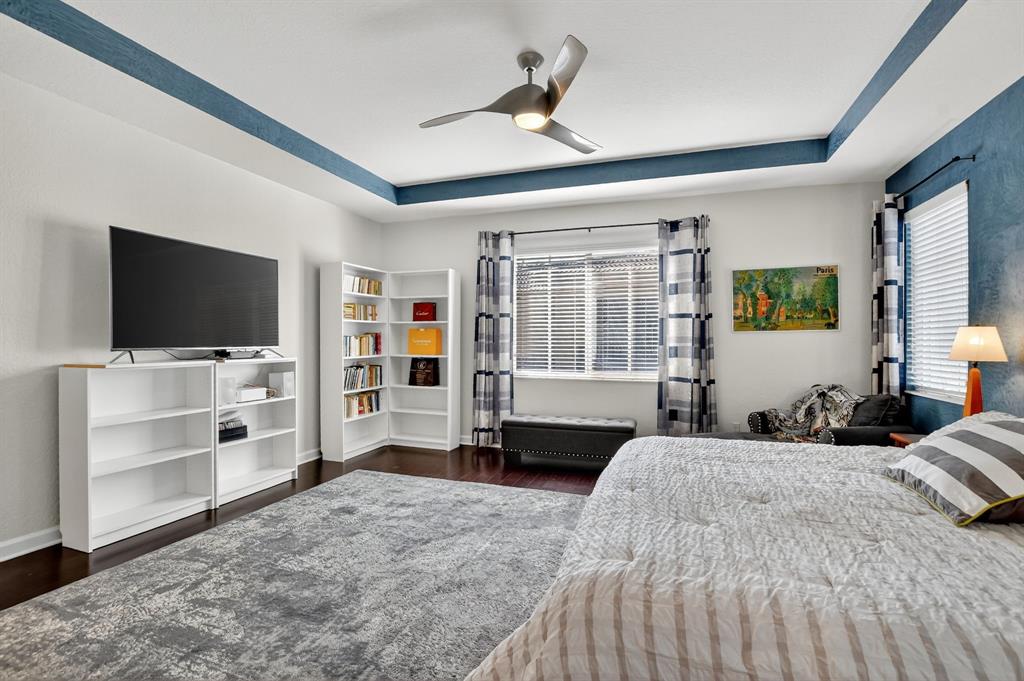 591 Northwest Library Commons Way Boca Raton, FL 33432 - Photo 43 of 75 a spacious bedroom with a large bed and a flat tv screen on dresser
