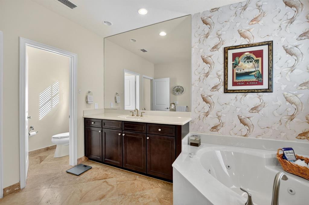 591 Northwest Library Commons Way Boca Raton, FL 33432 - Photo 48 of 75 a spacious bathroom with a tub sink and mirror