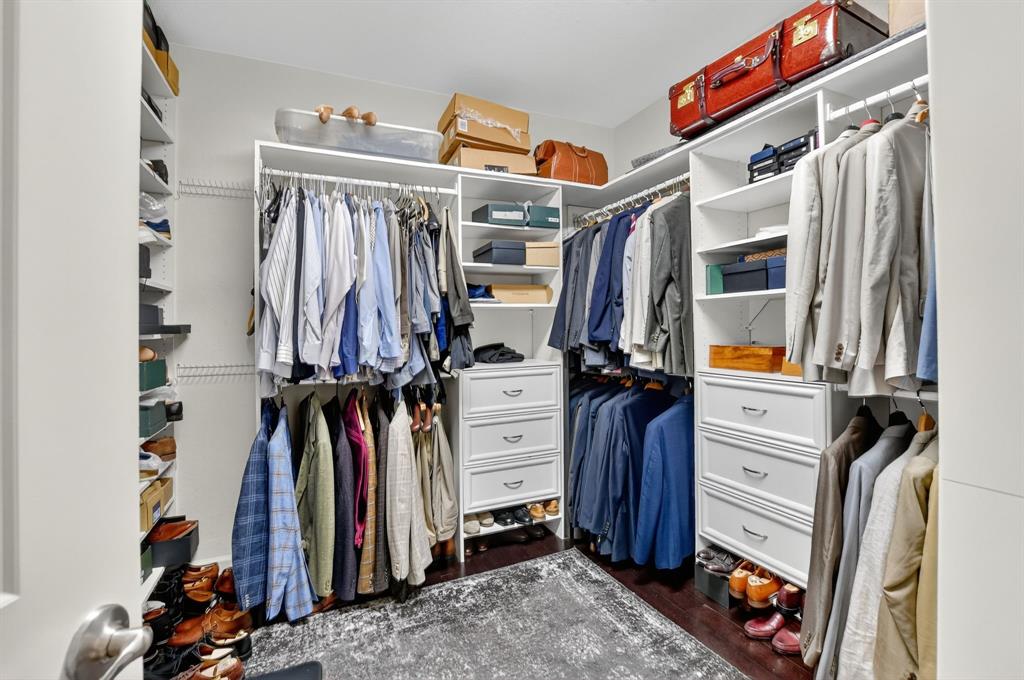 591 Northwest Library Commons Way Boca Raton, FL 33432 - Photo 49 of 75 a view of walk in closet with clothes and shoes